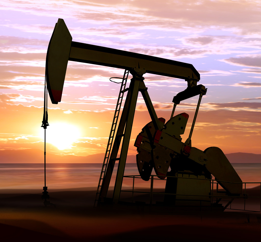 Silhouette of working oil pumps on sunset background.